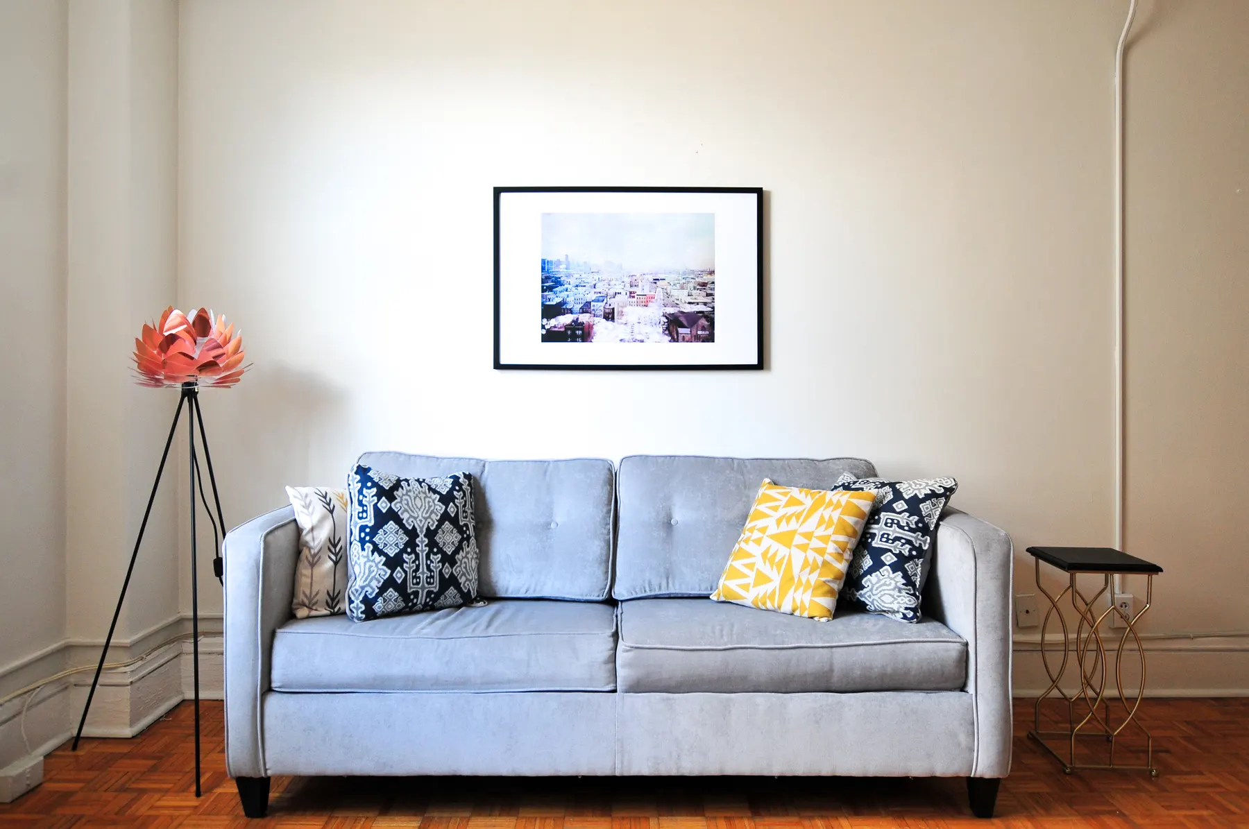 Living room with a gray sofa and a framed print above it
